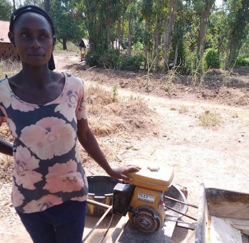 Mary Oko with her petrol-powered cassava grater in Woda community, Cross River State. Oko&rsquo;s top priority for her community&rsquo;s development is reliable power. Without it, she can only afford to operate her business in daytime hours and she spends a lot of time and money fueling and maintaining their aging machine&rsquo;s engine. (Photo: RMI)