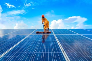 A,man,working,on,solar,panels