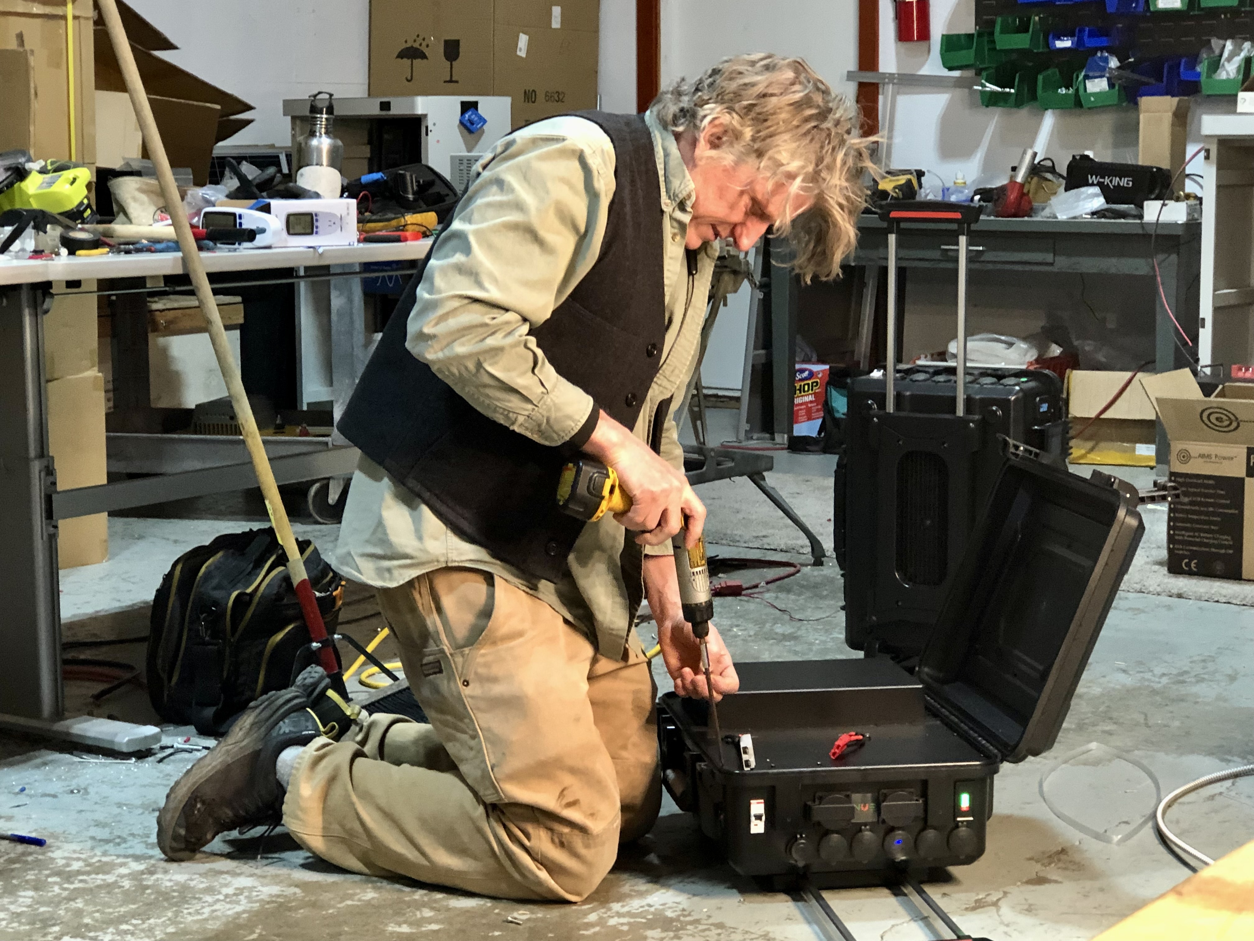 Eric Youngren, NUE vice president of product development, changes a unit to the Ukrainian voltage and frequency. Courtesy of Footprint Project
