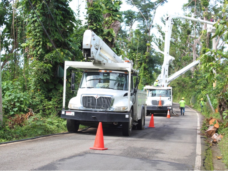 Utility trucks help workers restore electrical power after Hurricane Maria in Palmer, Puerto Rico. Photo by By Pamela Brick/Shutterstock.com