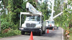 Utility trucks help workers restore electrical power after Hurricane Maria in Palmer, Puerto Rico. Photo by By Pamela Brick/Shutterstock.com