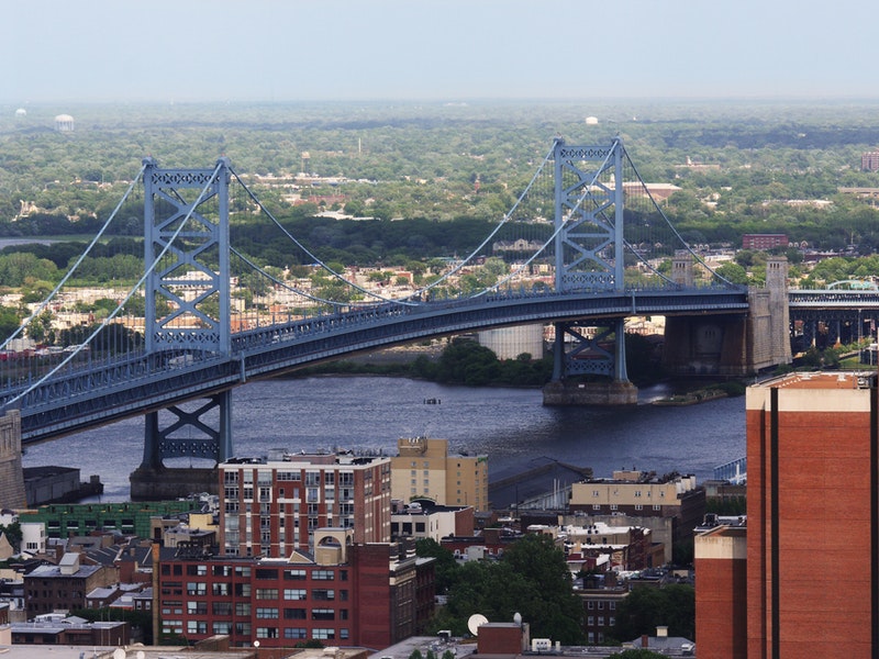 The Benjamin Franklin Bridge crosses the Delaware River connecting Philadelphia, Pennsylvania and Camden New Jersey. The suspension bridge has been in service since 1926. Credit Shutterstock.com