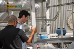 Two UNM graduate students, who are also involved in the NM SMART Grid Center project, working at the Mesa del Sol microgrid site in 2019. Credit: NM EPSCoR/NM SMART Grid Center Two UNM graduate students, who are also involved in the NM SMART Grid Center project, working at the Mesa del Sol microgrid site in 2019. Credit: NM EPSCoR/NM SMART Grid Center