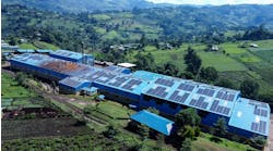 Figure 1: An aerial photo the Mbogo Valley Tea Factory with the roof top PV array driving its newly installed DC Microgrid. The Microgrid helps the factory stay in operation even when it loses grid power. The photo also shows a few of the 10,288 outgrower tea fields in the area whose livelihoods are supported by the tea factory.