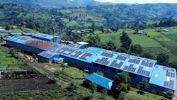 Figure 1: An aerial photo the Mbogo Valley Tea Factory with the roof top PV array driving its newly installed DC Microgrid. The Microgrid helps the factory stay in operation even when it loses grid power. The photo also shows a few of the 10,288 outgrower tea fields in the area whose livelihoods are supported by the tea factory. Figure 1: An aerial photo the Mbogo Valley Tea Factory with the roof top PV array driving its newly installed DC Microgrid. The Microgrid helps the factory stay in operation even when it loses grid power. The photo also shows a few of the 10,288 outgrower tea fields in the area whose livelihoods are supported by the tea factory.