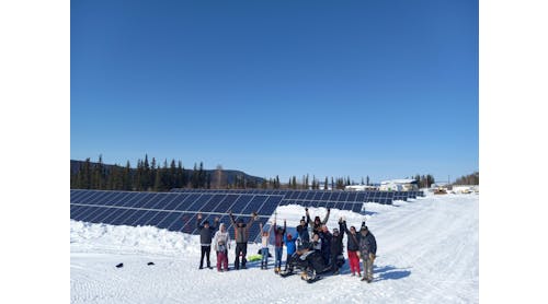Residents of Hughes, Alaska next to solar installation (source: Eddie Dellamary)