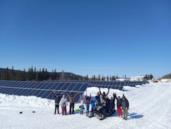 Residents of Hughes, Alaska next to solar installation (source: Eddie Dellamary) Residents of Hughes, Alaska next to solar installation (source: Eddie Dellamary)
