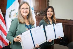 From left, New Sun Road CEO Adrienne Pierce and Ana Chan, National Secretary of Science and Technology for Guatemala, pose with documents about the U.S. Trade and Development Agency grants for solar-powered digital community projects.