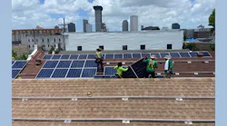 Louisiana Green Corps workers install solar panels at Grace at the Green Light, a nonprofit that helps feed the homeless.