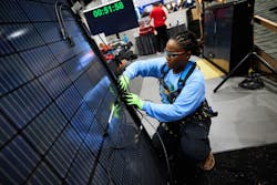 An installer works intently during the Solar Games competition at Intersolar in San Diego. An installer works intently during the Solar Games competition at Intersolar in San Diego.