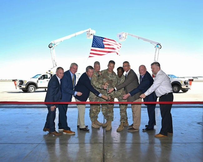 Fort Cavazos, state and local leadership prepare to cut the ribbon to celebrate the newly operational intelligent energy grid sustainability and restoration microgrid tool during a ceremony at Robert Gray Army Airfield. (U.S. Army photo by Scott Darling, Fort Cavazos Public Affairs)