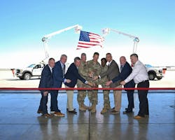 Fort Cavazos, state and local leadership prepare to cut the ribbon to celebrate the newly operational intelligent energy grid sustainability and restoration microgrid tool during a ceremony at Robert Gray Army Airfield. (U.S. Army photo by Scott Darling, Fort Cavazos Public Affairs)