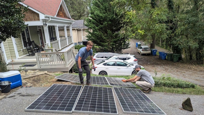Will Heegaard, Footprint Project, left, and Cade Spencer, Renewable Design Associates, installing a POP-UP EMERGENCY CRITICAL SERVICES MICROGRID at CooperRiis Mental Health Halfway house for lights and refrigerators on day three of the Helene recovery
