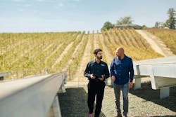 Yassine Askri, microgrid specialist with Schneider Electric (left) walks and chats with Abel Lopez, facilities manager of the Napa winery Domaine Carneros, while surveying the winery's solar and battery storage microgrid. Yassine Askri, microgrid specialist with Schneider Electric (left) walks and chats with Abel Lopez, facilities manager of the Napa winery Domaine Carneros, while surveying the winery's solar and battery storage microgrid.
