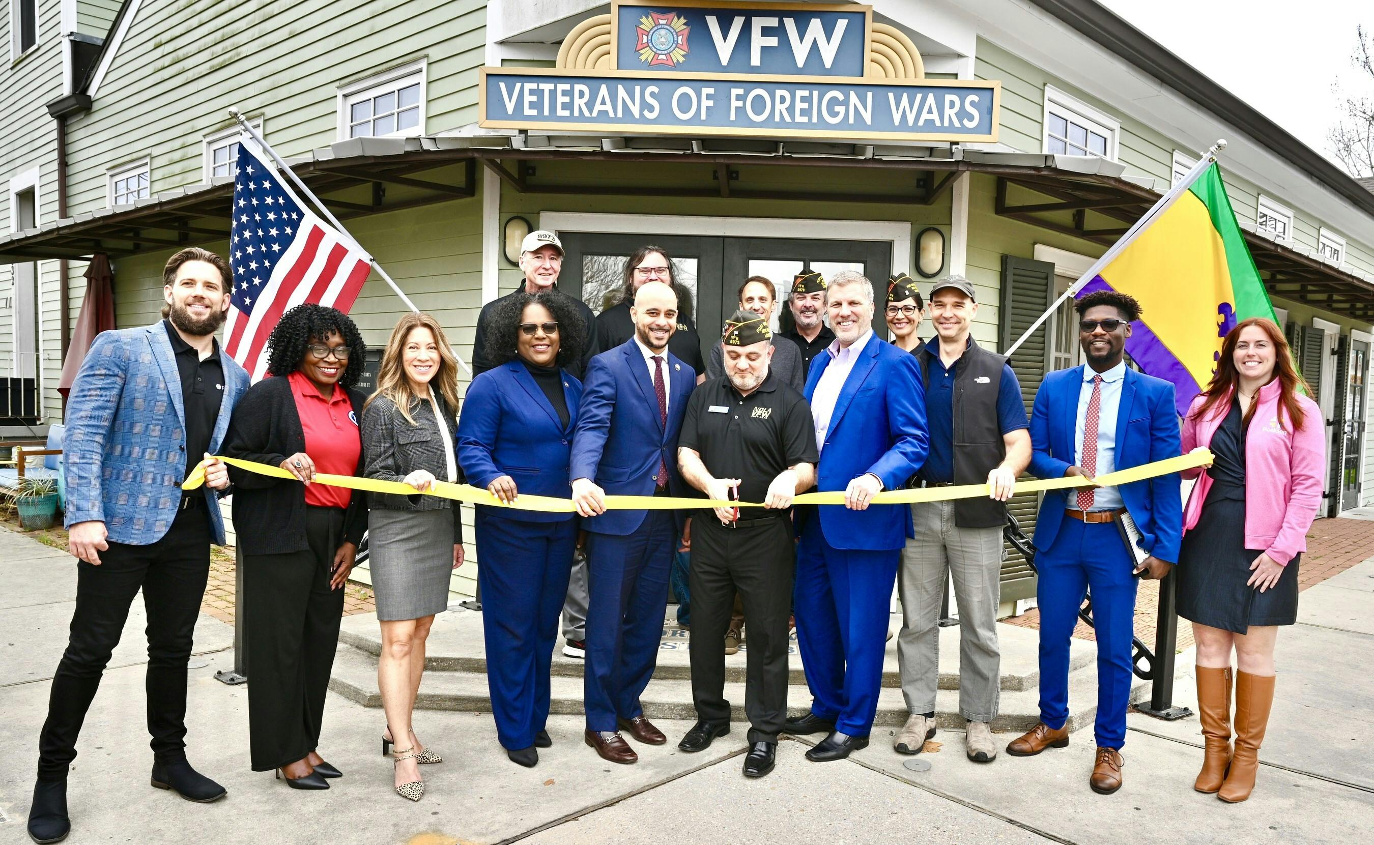 A group of leaders from project developers, state and local officials and post commander pose in front of the New Orleans VFW Post 8973 celebrating completion of the solar and battery storage installation. Image credit PRNewswire