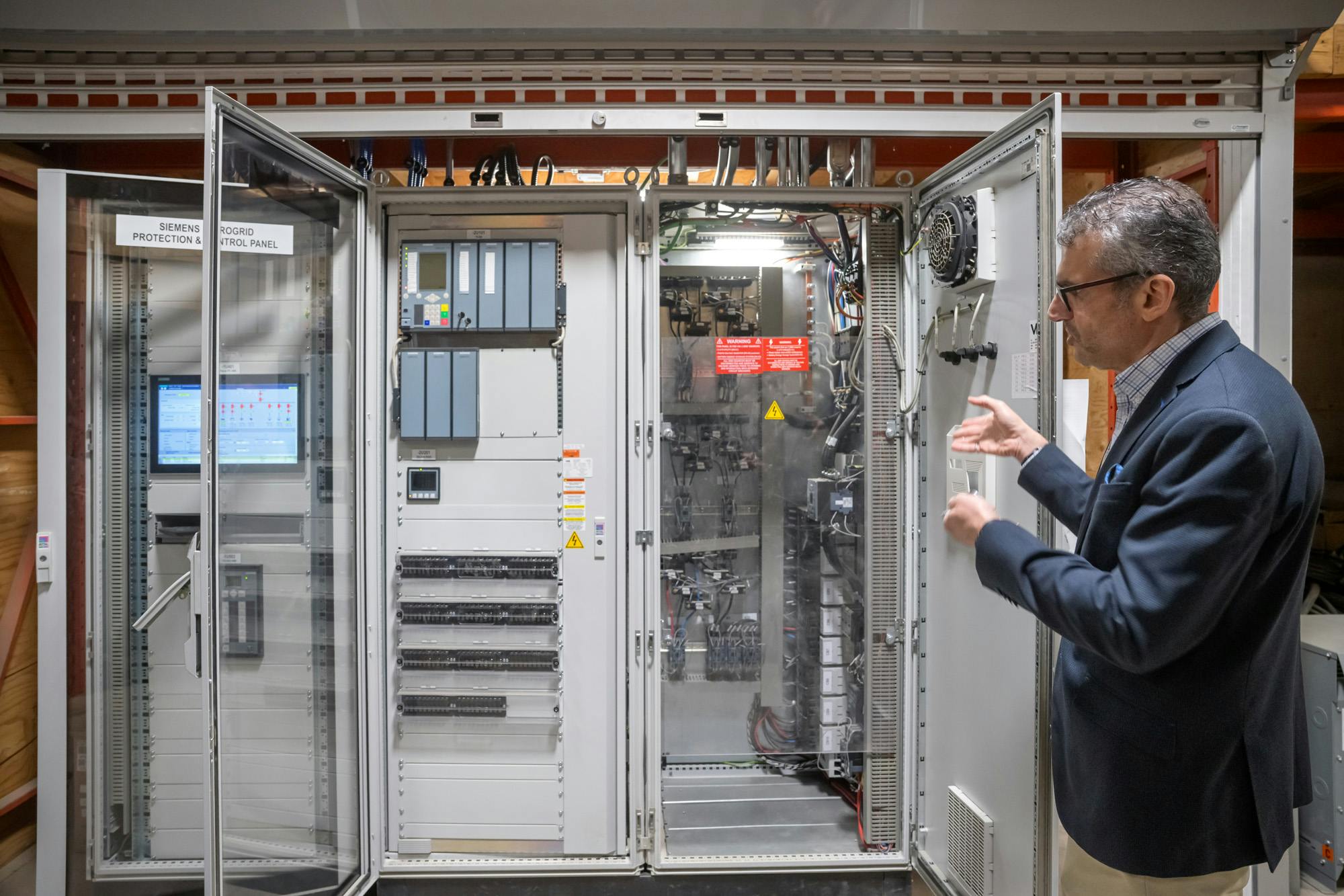 Dr. Ifran Al-Anbagi, director of the Microgrid Living Lab and associate professor in the Faculty of Engineering and Applied Science, stands in front of the microgrid's control center. (Photo by U of R Photography)