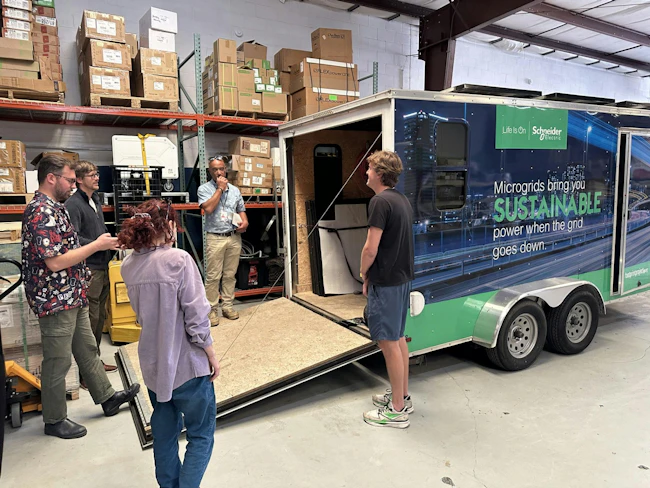 Some of the Footprint Project team gathers around in preparing to roll out a mobile microgrid.