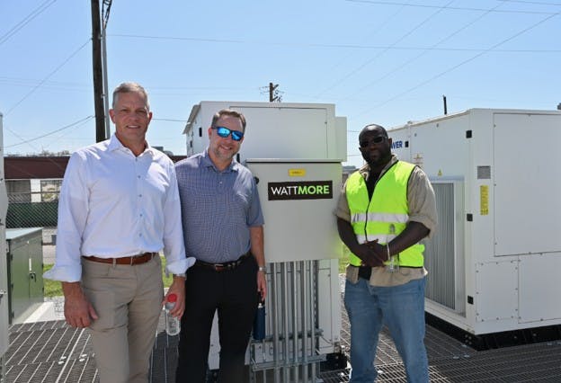 Eos Energy Enterprise Chief Commercial Officer Nathan Kroeker, left, stands in front of the new Lincoln Electric System (LES) battery storage project with WATTMORE CEO J.W. Postal and EOS senior technician Dallas Davidson. Image credit Eos and WATTMORE