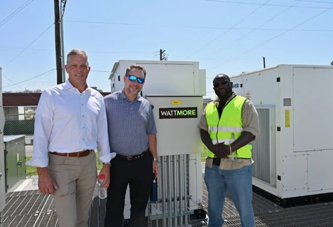 Eos Energy Enterprise Chief Commercial Officer Nathan Kroeker, left, stands in front of the new Lincoln Electric System (LES) battery storage project with WATTMORE CEO J.W. Postal and EOS senior technician Dallas Davidson. Image credit Eos and WATTMORE