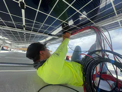 Worker connecting solar portion of the Chiricahua Community Health Center microgrid in Arizona. Image credit Collective Energy